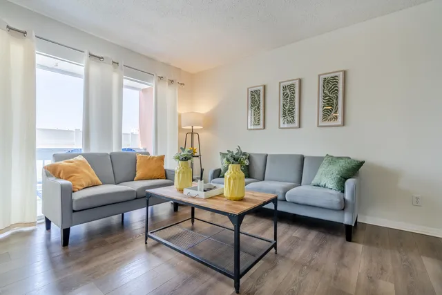 a living room with furniture and a potted plant