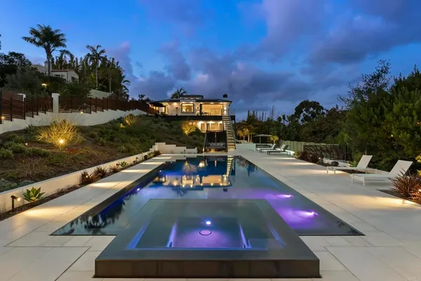 a view of a swimming pool with lounge chairs