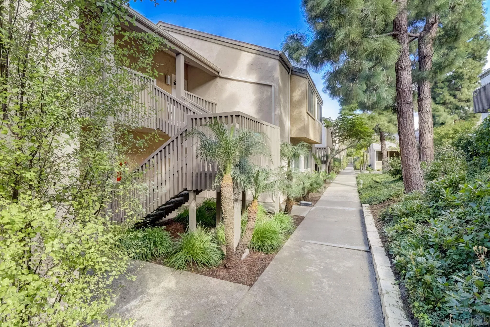 a pathway of a house with a yard