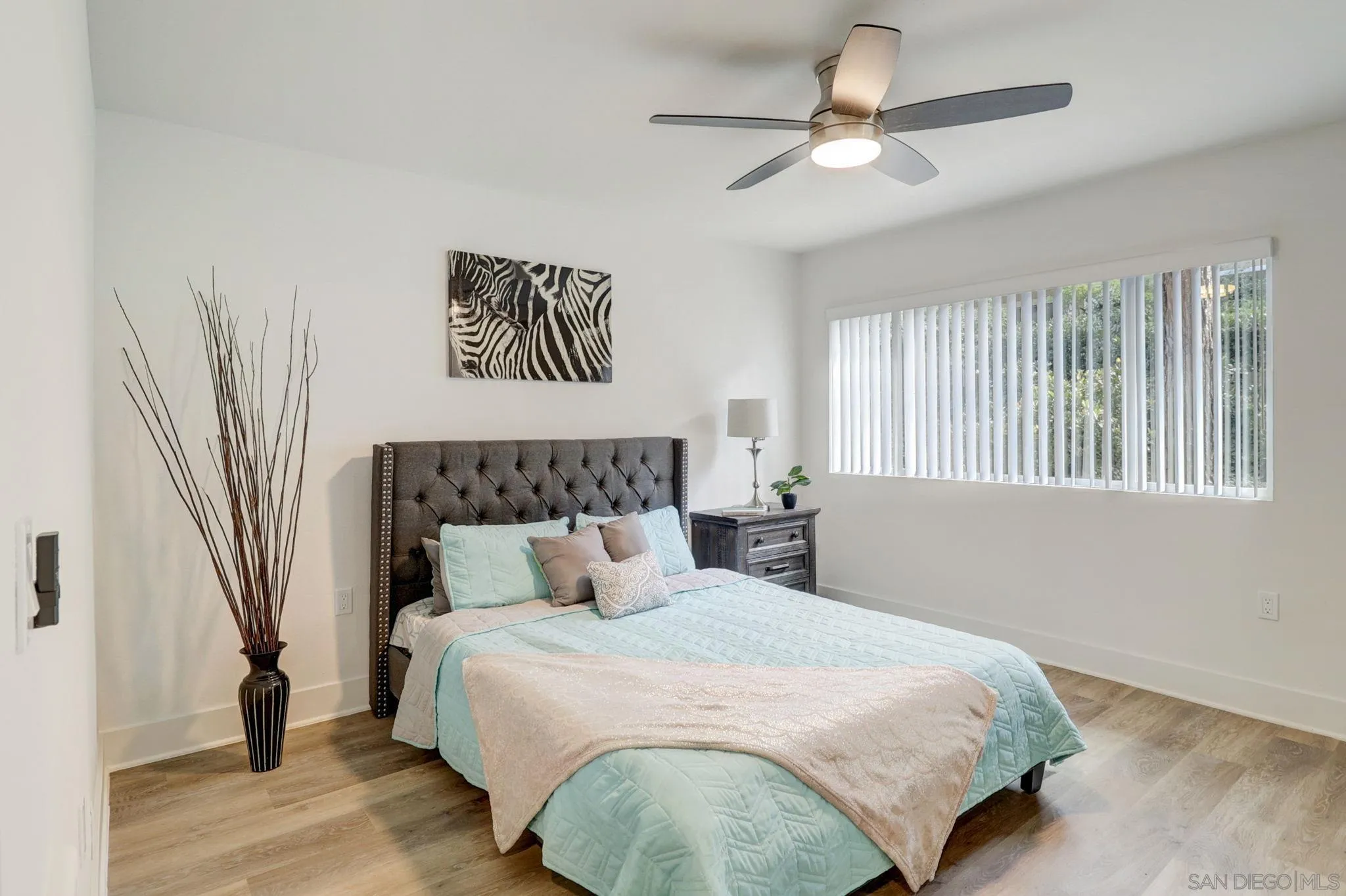 8660 Via Mallorca, Unit B La Jolla, CA 92037 - Photo 12 of 27 a bedroom with a large bed and a chandelier