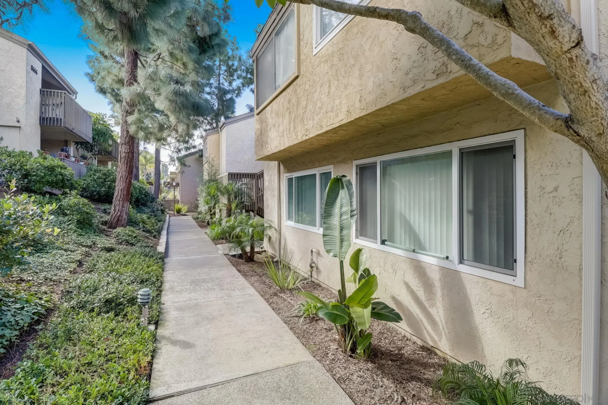 8660 Via Mallorca, Unit B La Jolla, CA 92037 - Photo 2 of 27 a front view of a house with an outdoor space