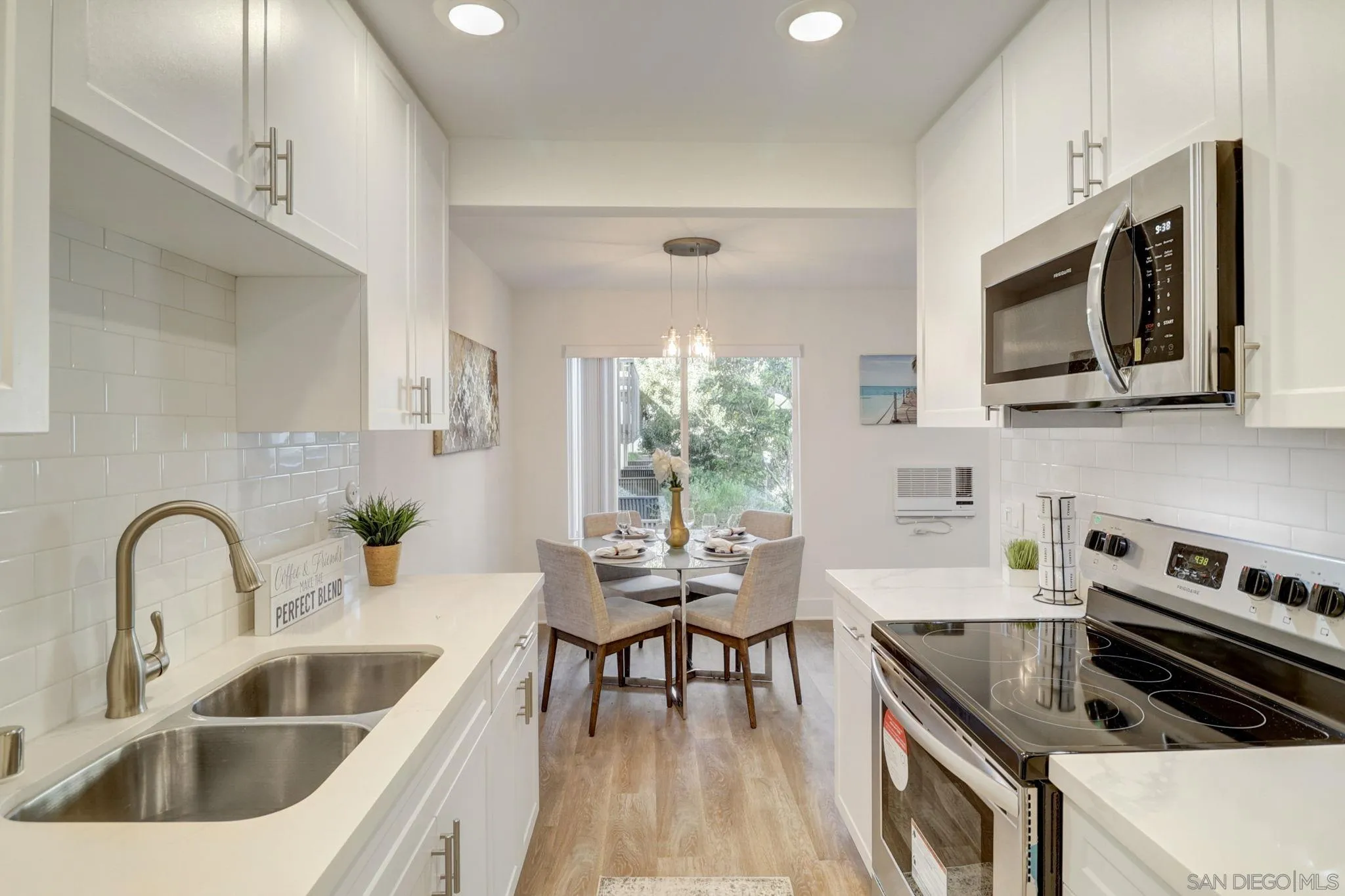 8660 Via Mallorca, Unit B La Jolla, CA 92037 - Photo 8 of 27 a kitchen with a stove a sink and a microwave