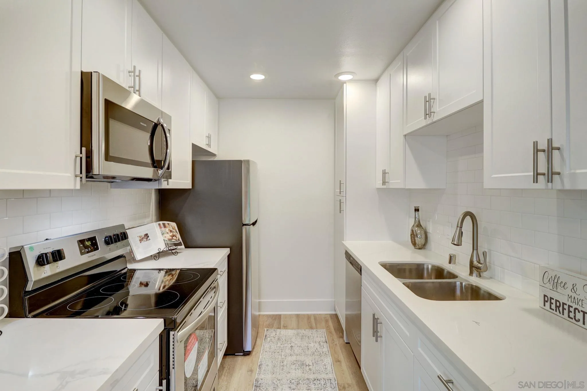 8660 Via Mallorca, Unit B La Jolla, CA 92037 - Photo 10 of 27 a kitchen with stainless steel appliances granite countertop a sink stove and cabinets