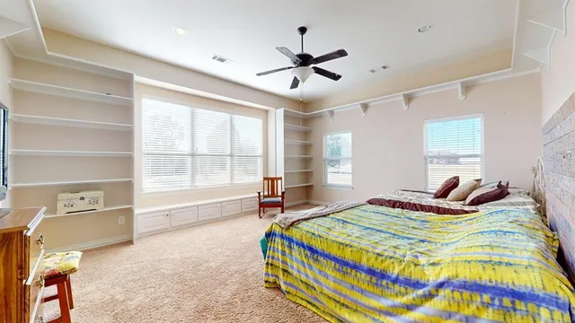 a bedroom with a bed and a large window with the outer view