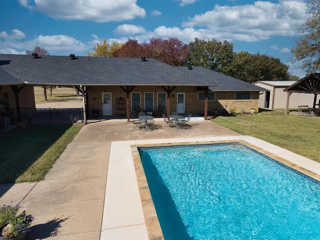 a swimming pool with outdoor seating