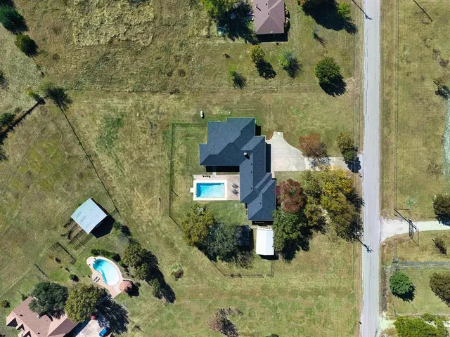 an aerial view of a house with a yard