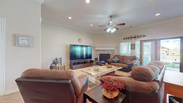 a living room with furniture a chandelier and a flat screen tv