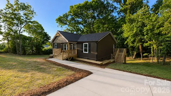 a view of a house with yard and tree s
