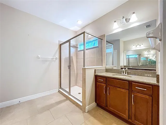 a bathroom with a granite countertop sink mirror and