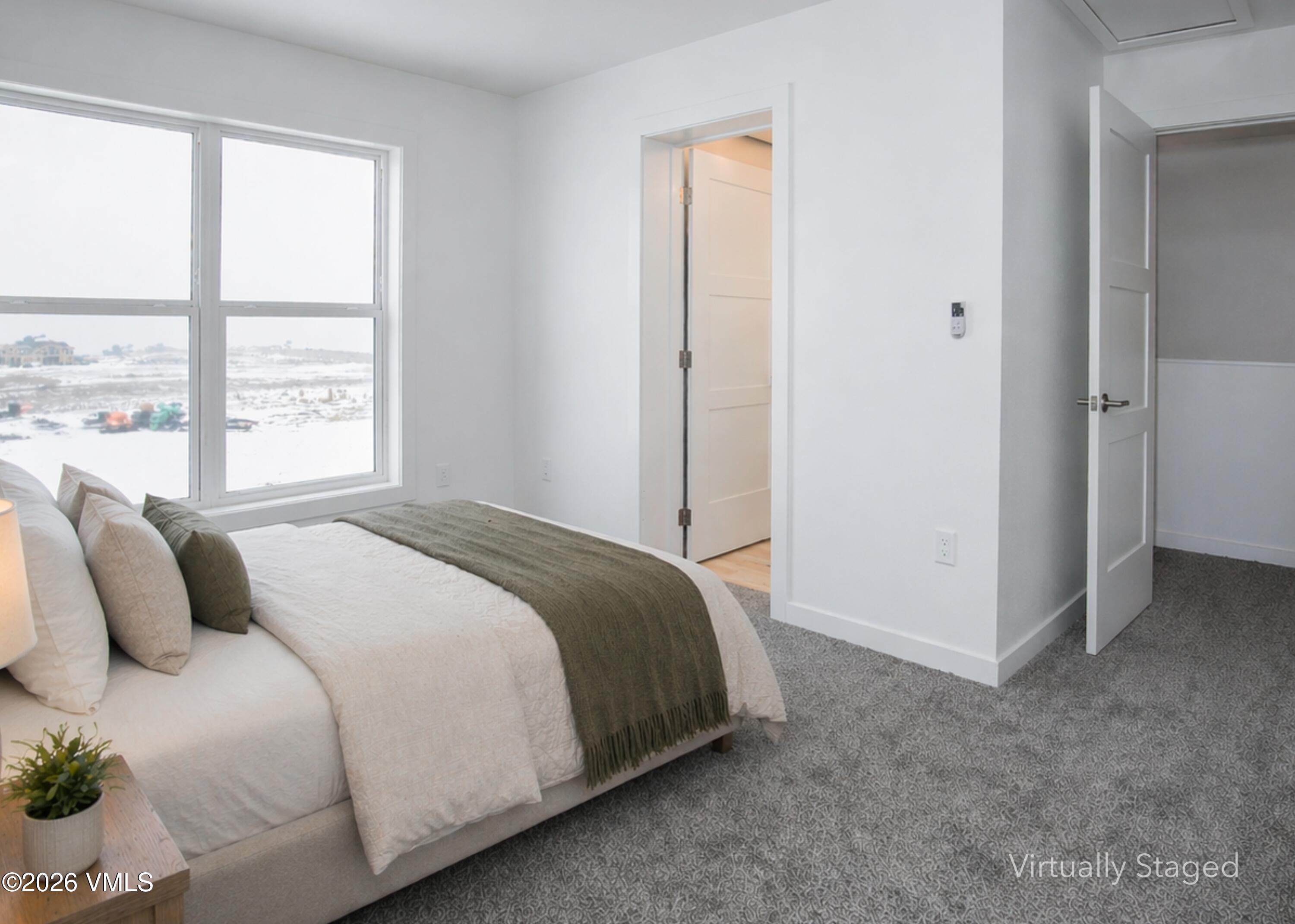 90 Comanche Way Gypsum, CO 81637 - Photo 3 of 46 a bedroom with a bed and a window