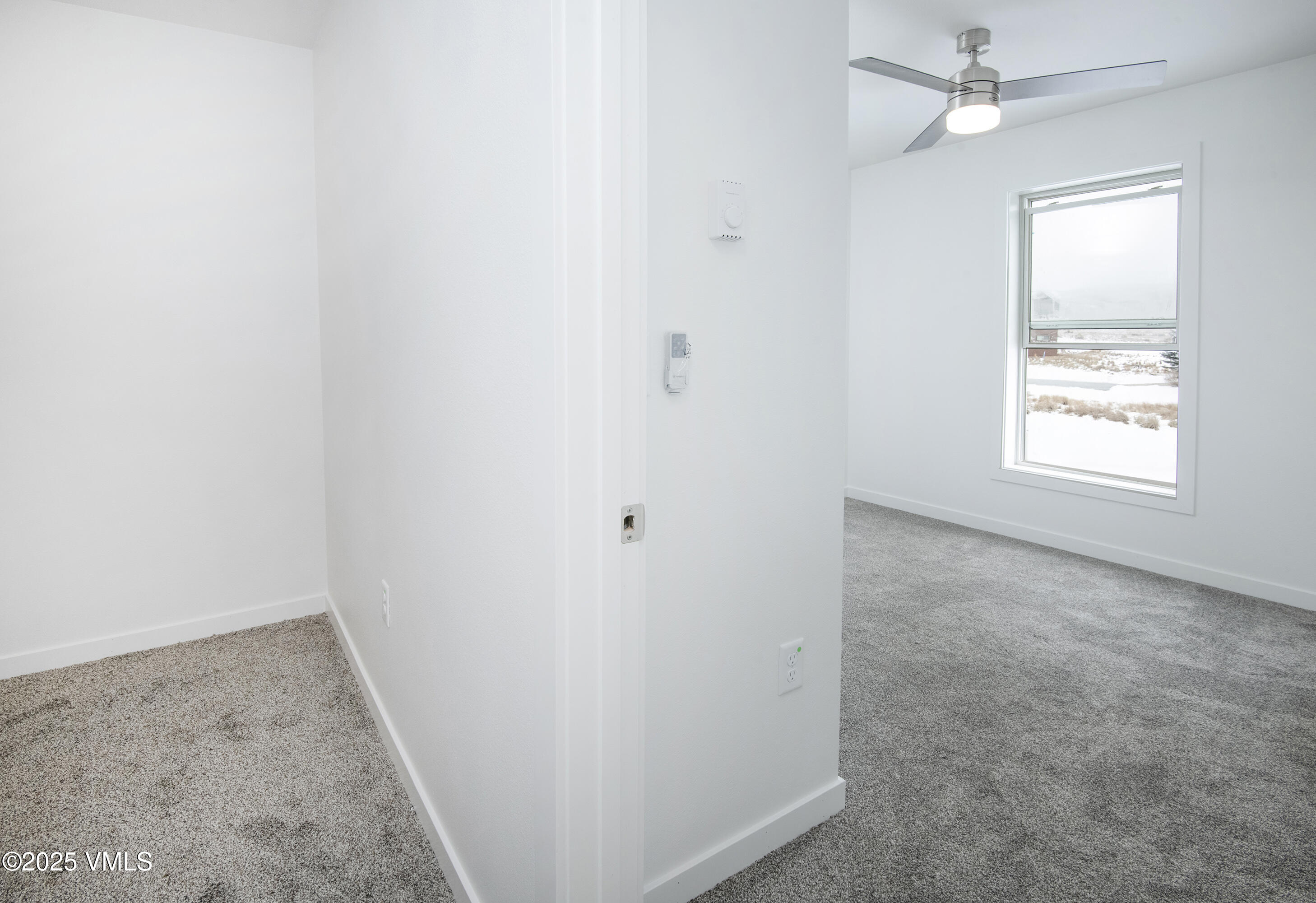90 Comanche Way Gypsum, CO 81637 - Photo 38 of 46 an empty room with windows and ceiling fan