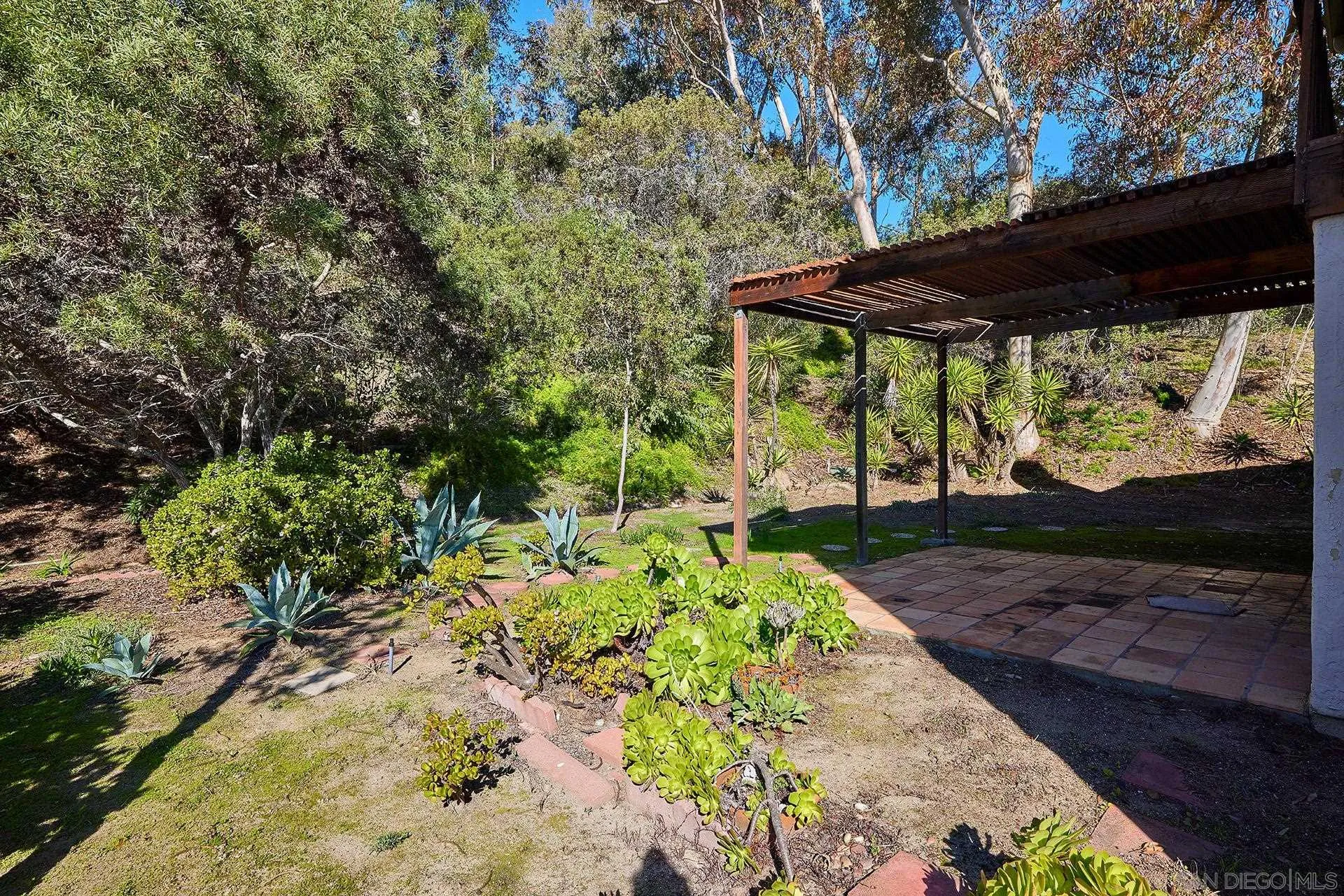 138 Townwood Way Encinitas, CA 92024 - Photo 14 of 48 a view of backyard with a table and chairs under an umbrella