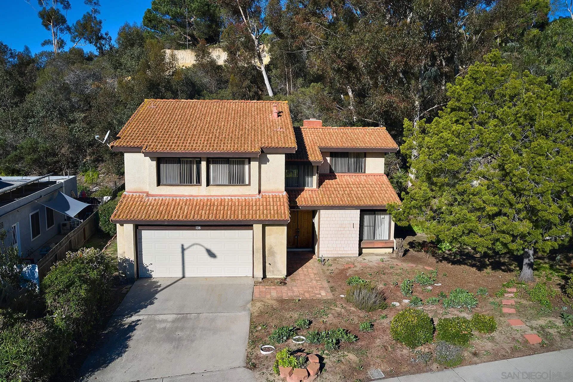 138 Townwood Way Encinitas, CA 92024 - Photo 25 of 48 a front view of a house with a yard and garage