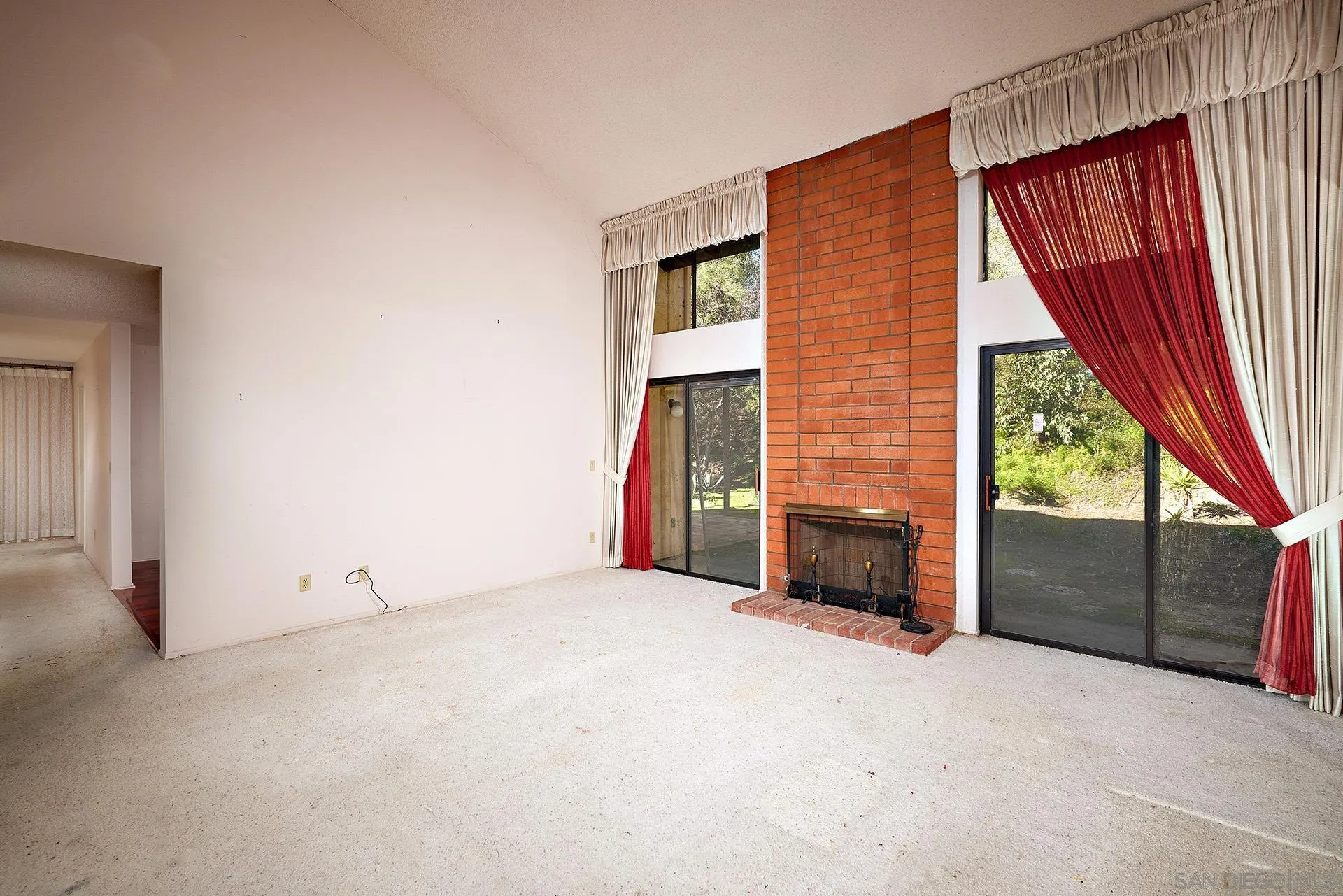 138 Townwood Way Encinitas, CA 92024 - Photo 4 of 48 a view of an empty room with a fireplace and windows