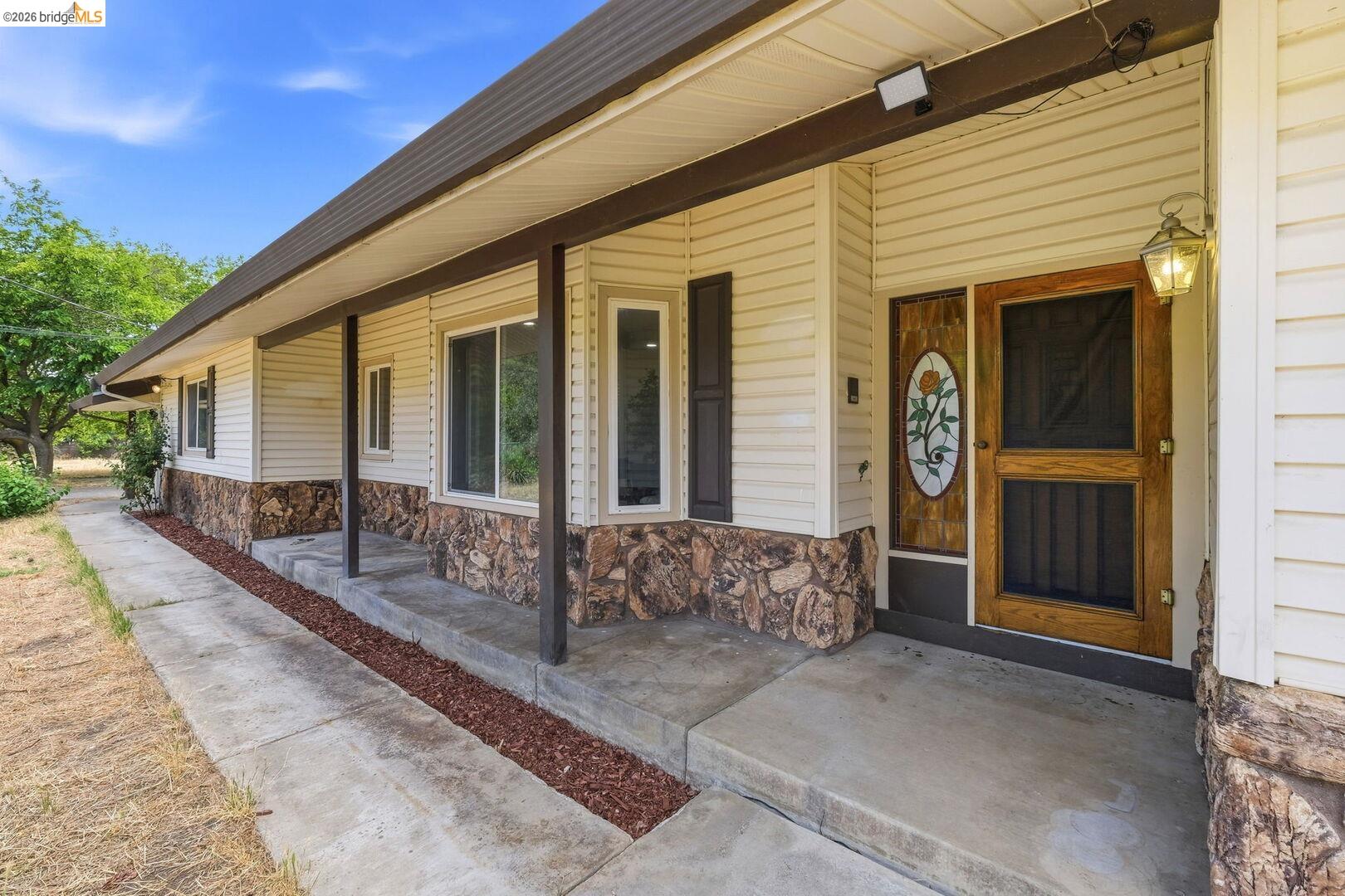 1590 Sunset Road Brentwood, CA 94513 - Photo 5 of 45 Exterior entry featuring light-colored siding and a stone facade
