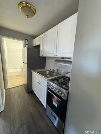 a kitchen with a stove and a refrigerator