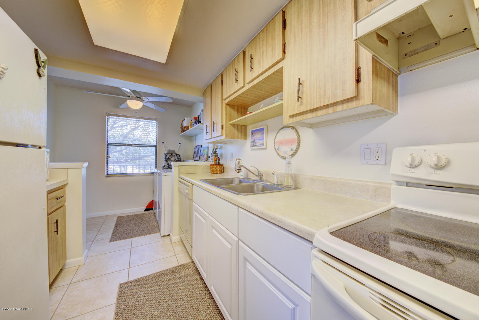 500 Catalina Road, Unit 405 Cocoa Beach, FL 32931 - Photo 3 of 22 Kitchen & Laundry - Door to Porch