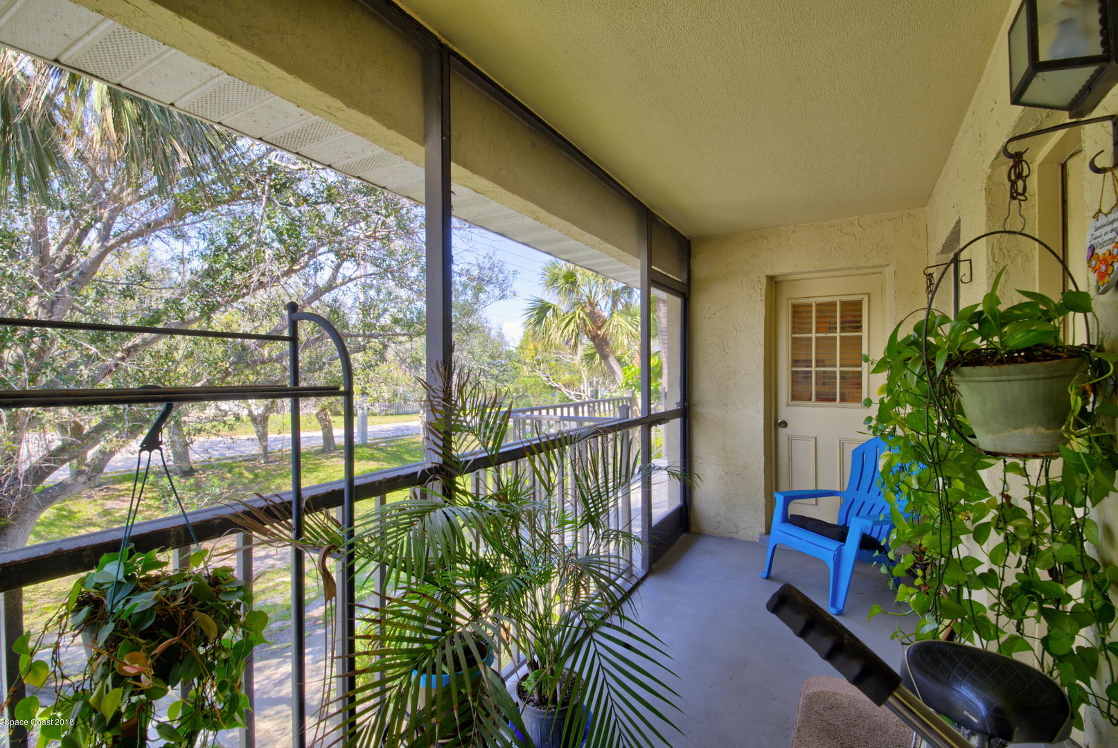 500 Catalina Road, Unit 405 Cocoa Beach, FL 32931 - Photo 8 of 22 Screen Enclosed Porch - Door to Kitchen