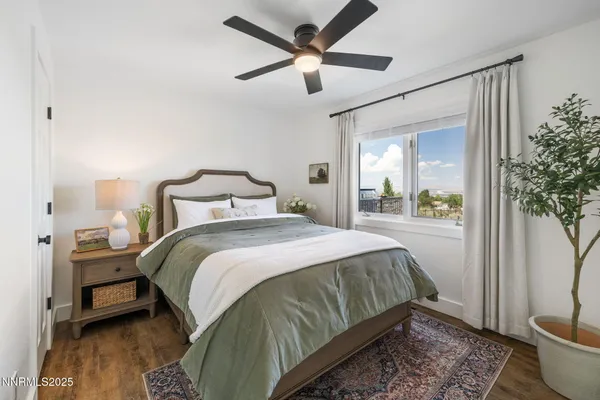 a view of room with hardwood floor and a ceiling fan