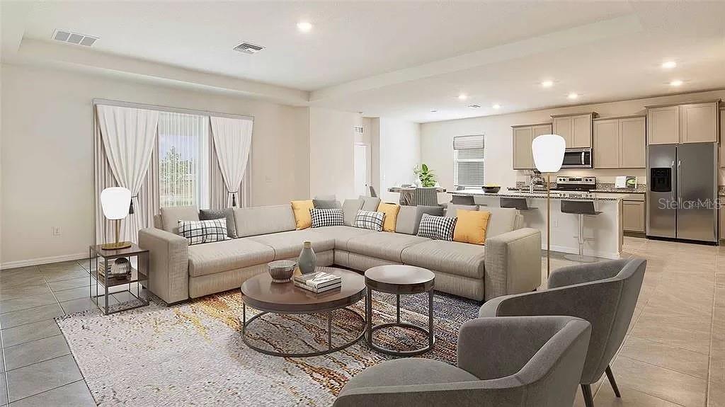 32226 Eldorado Cyn Loop Wesley Chapel, FL 33543 - Photo 6 of 18 a living room with furniture kitchen view and a large window