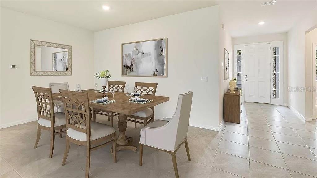 32226 Eldorado Cyn Loop Wesley Chapel, FL 33543 - Photo 8 of 18 a view of a dining room with furniture and wooden floor
