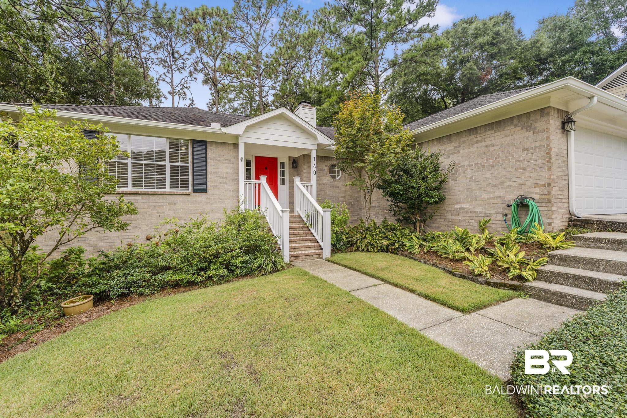 140 Hope Drive Daphne, AL 36526 - Photo 1 of 54 Single story home featuring a front yard, a garage, brick siding, a chimney, and a shingled roof