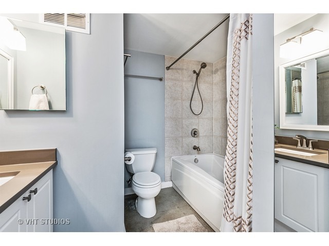939 West Madison Street, Unit 604 Chicago, IL 60607 - Photo 9 of 10 a bathroom with a toilet sink and shower