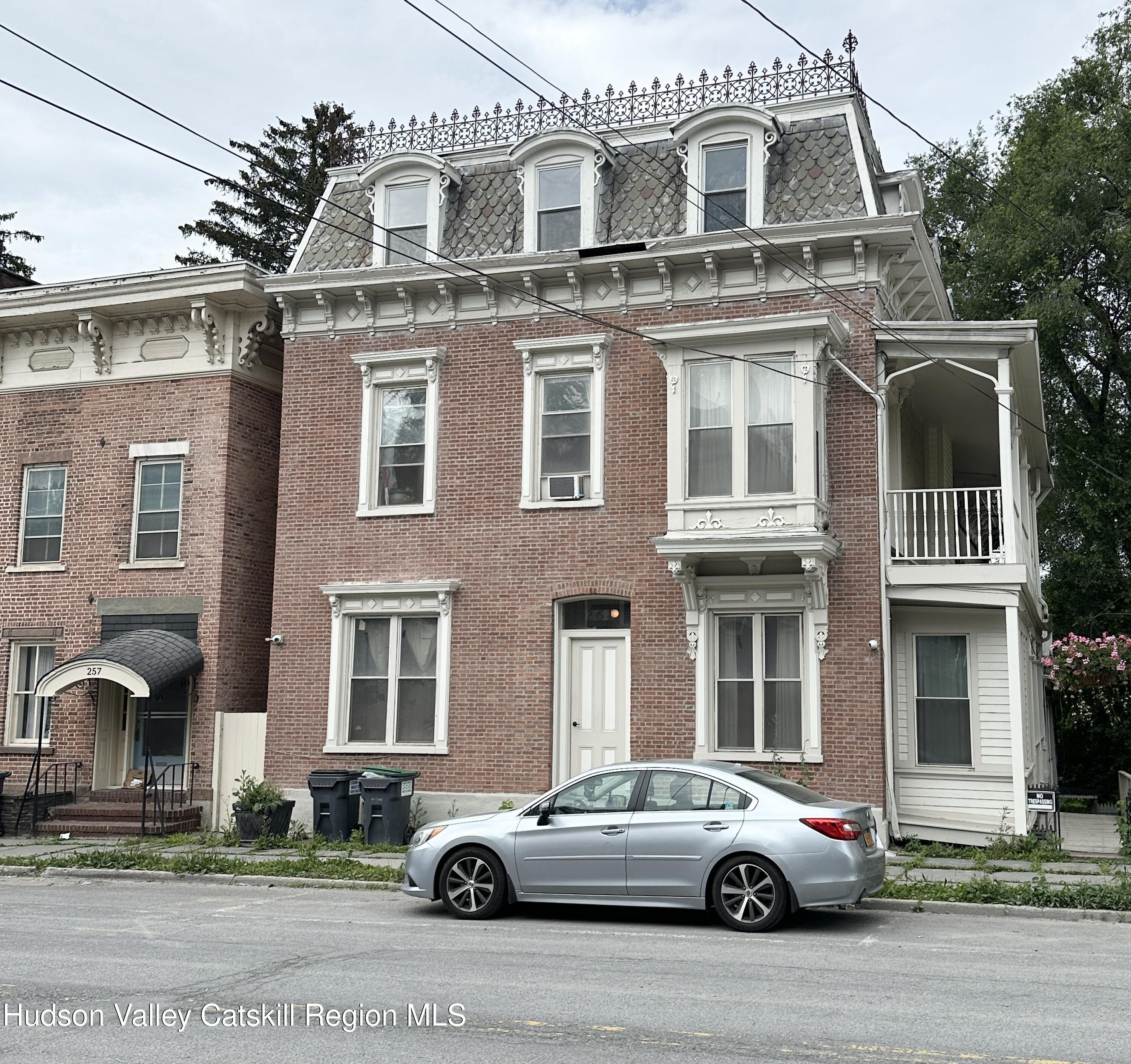261 Main Street, Unit 1 Catskill, NY 12414 - Photo 1 of 5 a front view of a residential apartment building with a yard