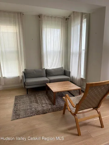 a living room with a couch and a window