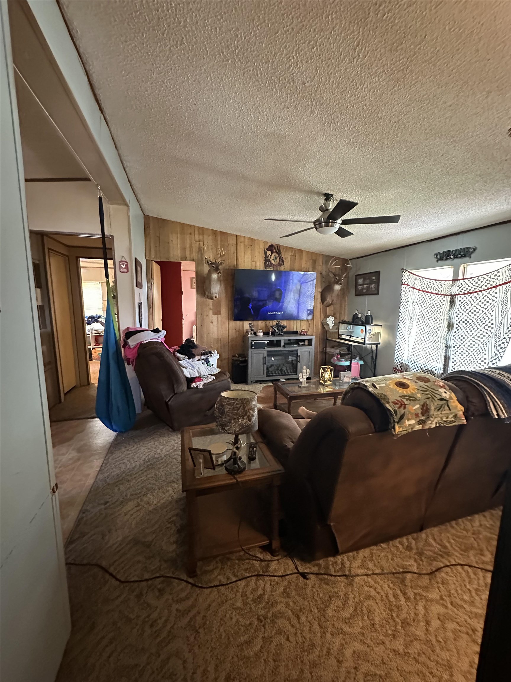 426 Gordon Road Ashland, MS 38603 - Photo 6 of 11 Angled wood-paneled accent wall with a ceiling fan overhead