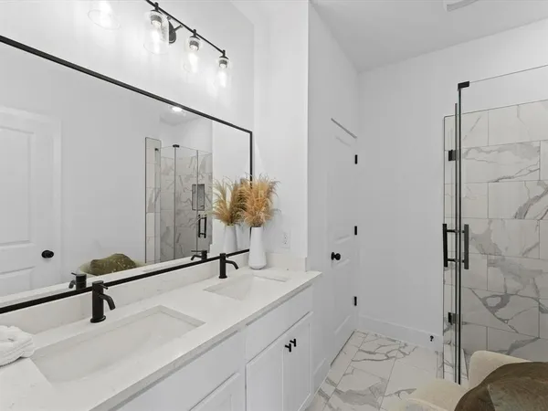 a bathroom with a sink and mirror with toilet