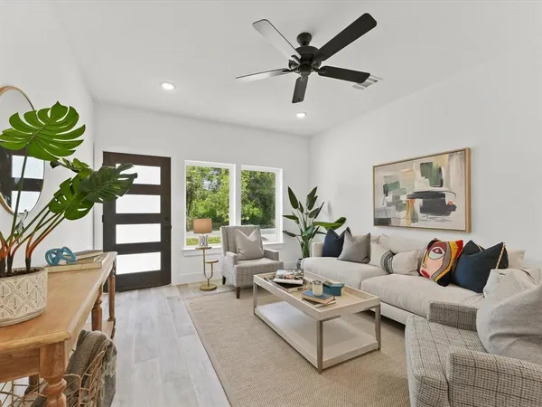 a living room with furniture and a large window
