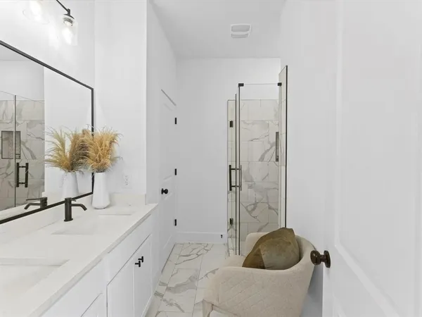 a bathroom with a tub shower and sink