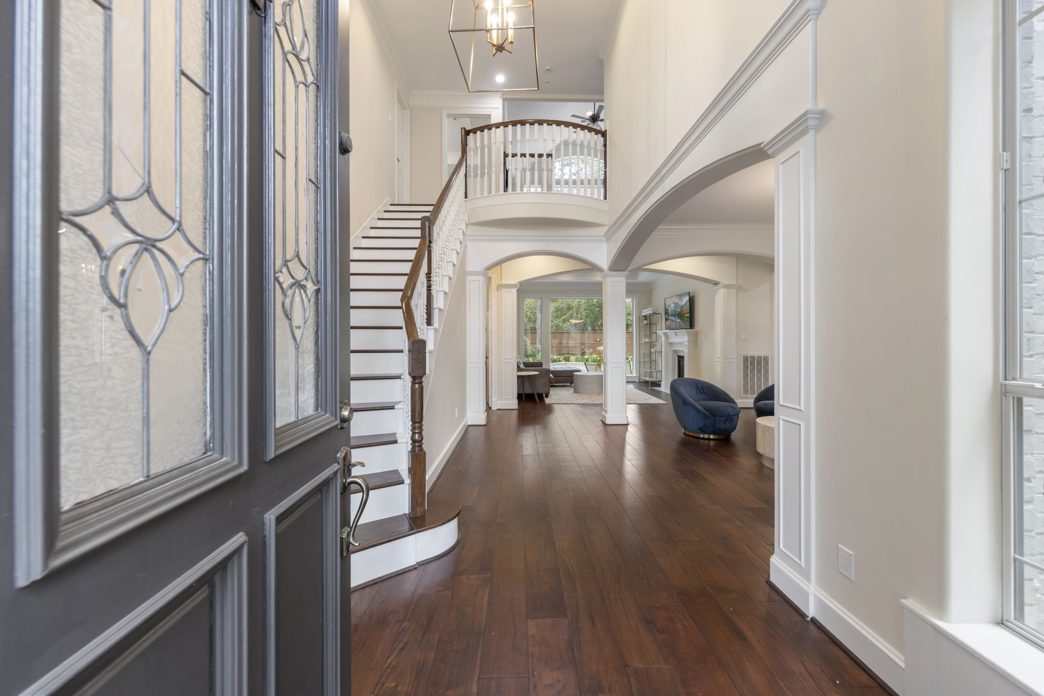 90 West Horizon Ridge Place Spring, TX 77381 - Photo 3 of 36 a view of a hallway to a livingroom with wooden floor and furniture