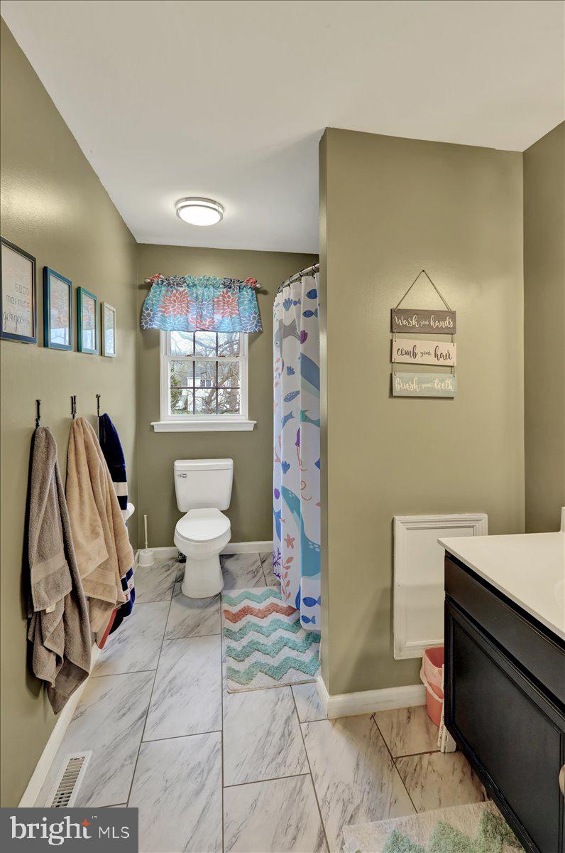 4 Elliot Drive Reading, PA 19606 - Photo 30 of 44 a living room with a couch and a potted plant