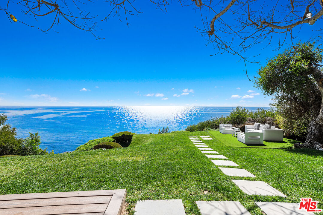 29122 Cliffside Drive Malibu, CA 90265 - Photo 11 of 39 a view of a garden with lawn chairs and a fire pit
