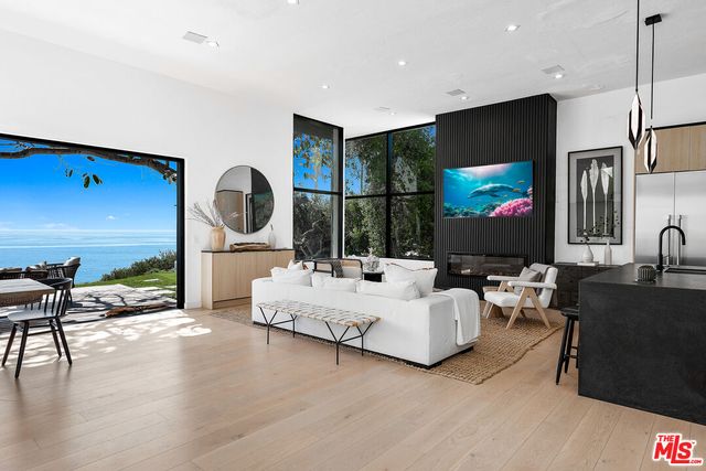 a living room with fireplace furniture and a flat screen tv