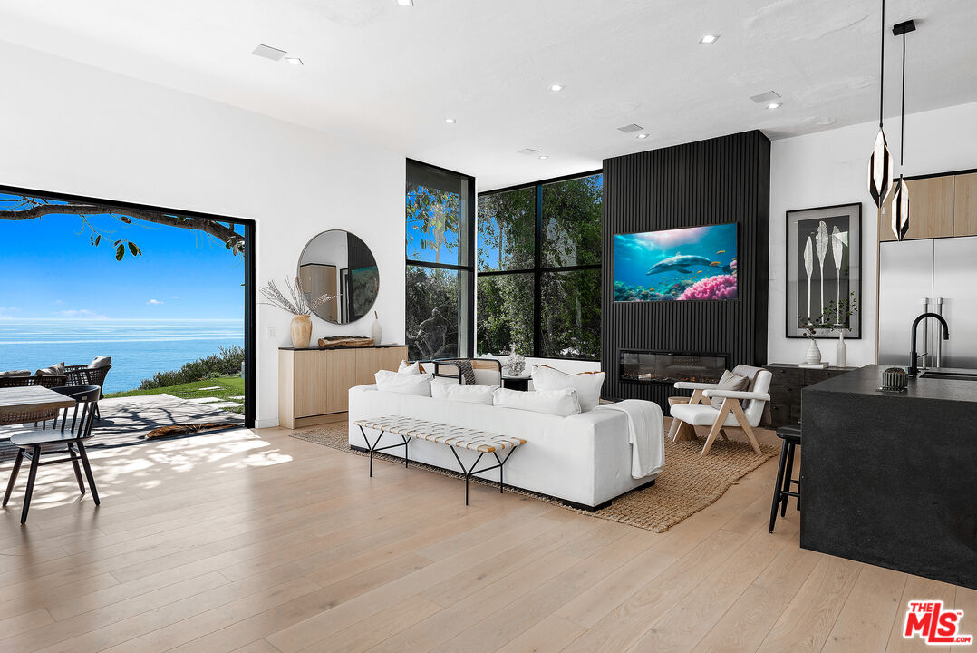 29122 Cliffside Drive Malibu, CA 90265 - Photo 12 of 39 a living room with fireplace furniture and a flat screen tv