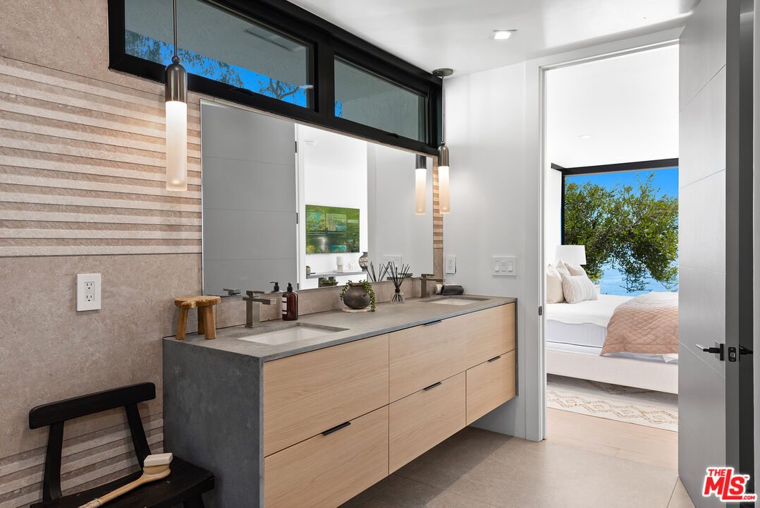 29122 Cliffside Drive Malibu, CA 90265 - Photo 19 of 39 a bathroom with a double vanity sink and mirror
