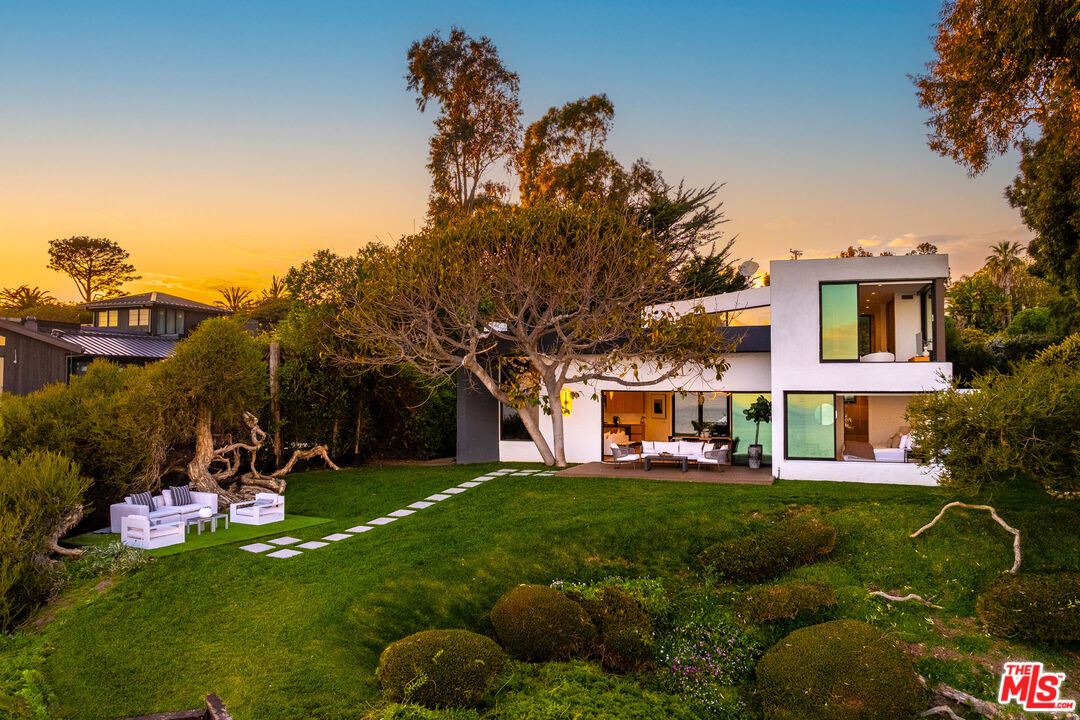 29122 Cliffside Drive Malibu, CA 90265 - Photo 27 of 39 a view of a white house with a big yard and large trees
