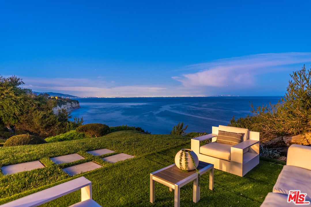 29122 Cliffside Drive Malibu, CA 90265 - Photo 33 of 39 a backyard of a house with table and chairs