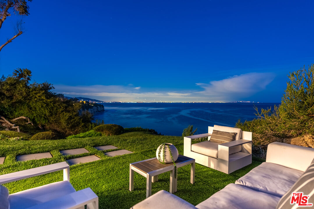 29122 Cliffside Drive Malibu, CA 90265 - Photo 35 of 39 a view of a chairs and table in patio with a yard
