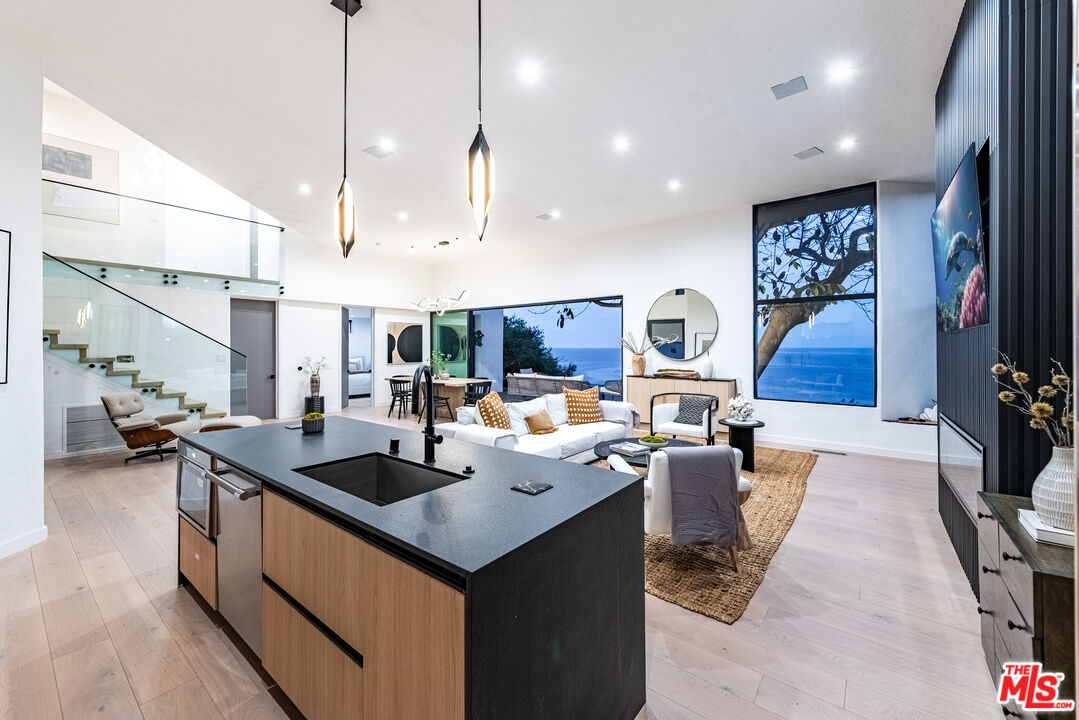 29122 Cliffside Drive Malibu, CA 90265 - Photo 36 of 39 a kitchen with counter space appliances and a living room view
