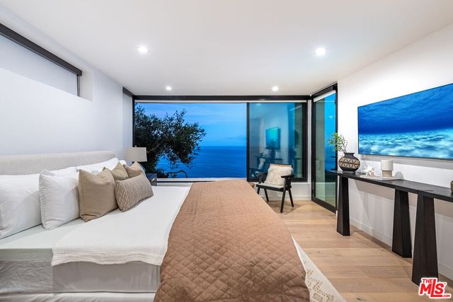 a bed room with bed and a large mirror