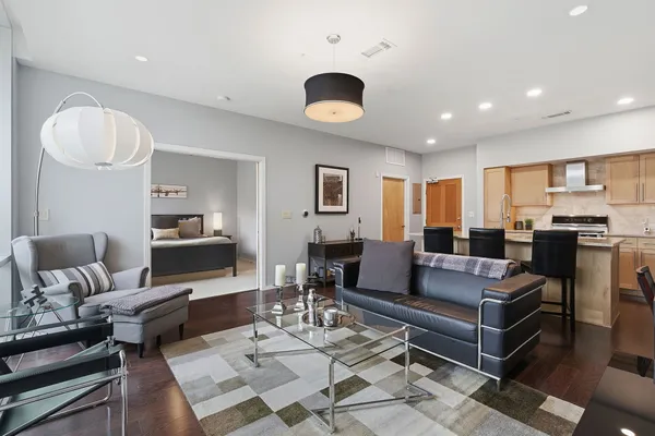 a living room with furniture and a view of kitchen