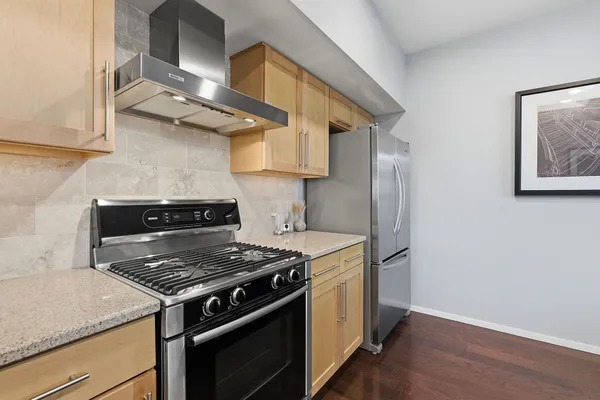a kitchen with stainless steel appliances granite countertop a stove and a sink