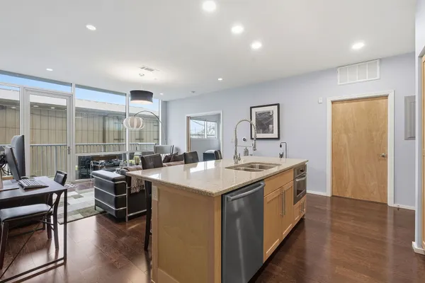 a kitchen with a stove a refrigerator and a dining table