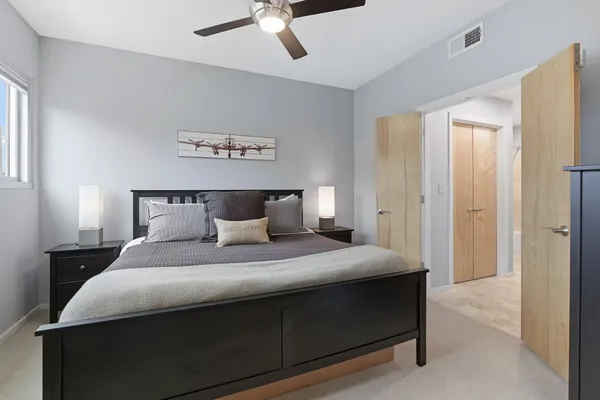 a bedroom with bed and window