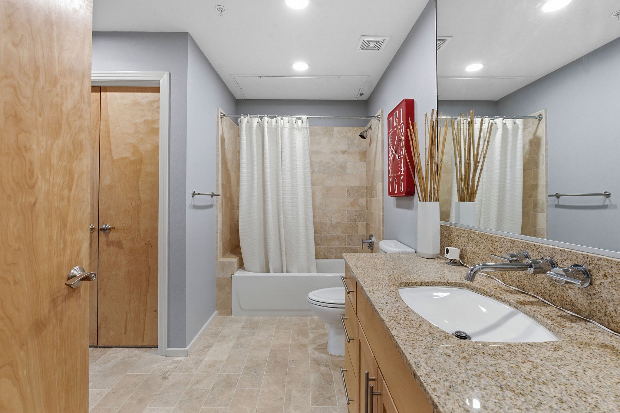 1600 Barton Springs Road, Unit 1106 Austin, TX 78704 - Photo 20 of 39 a bathroom with a granite countertop double vanity sink a mirror and a shower