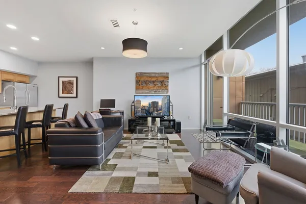 a living room with furniture and wooden floor